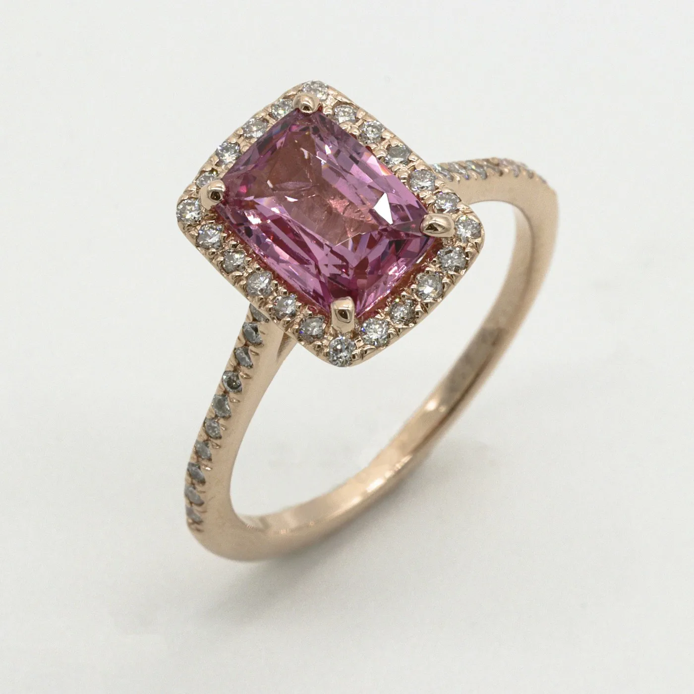 Warm gold jewelry catching direct sunlight on a pale stone